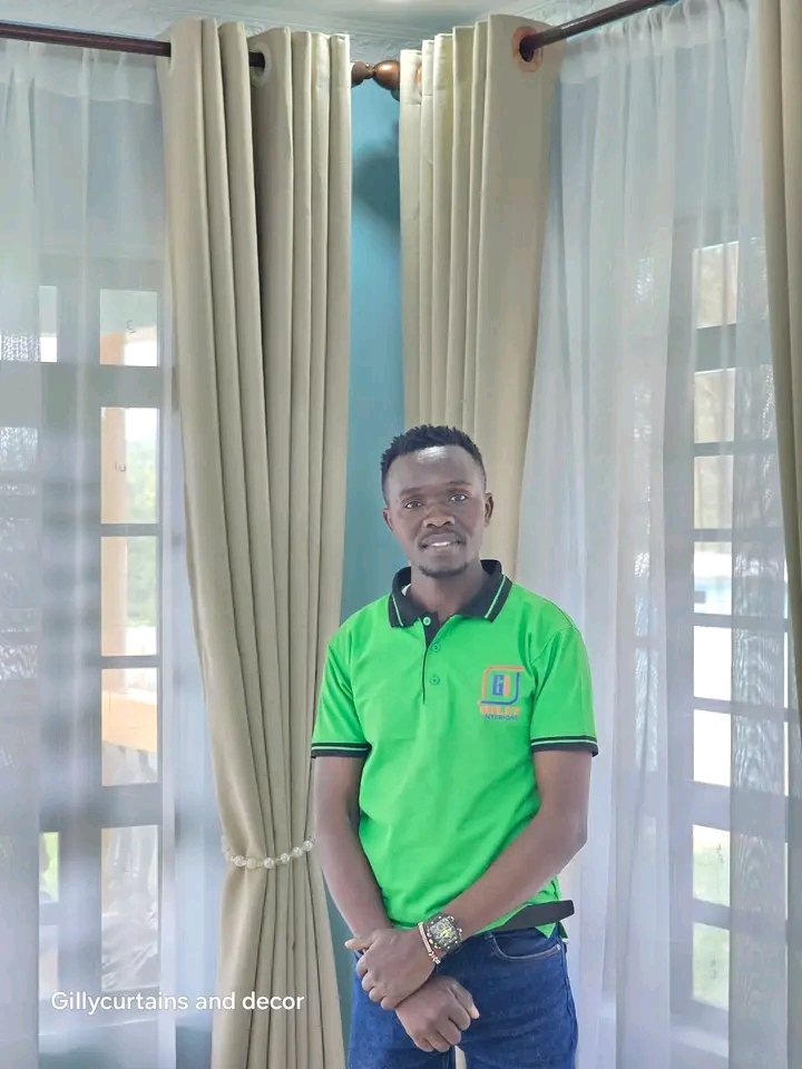 Gilly Interiors team member beside installed curtains